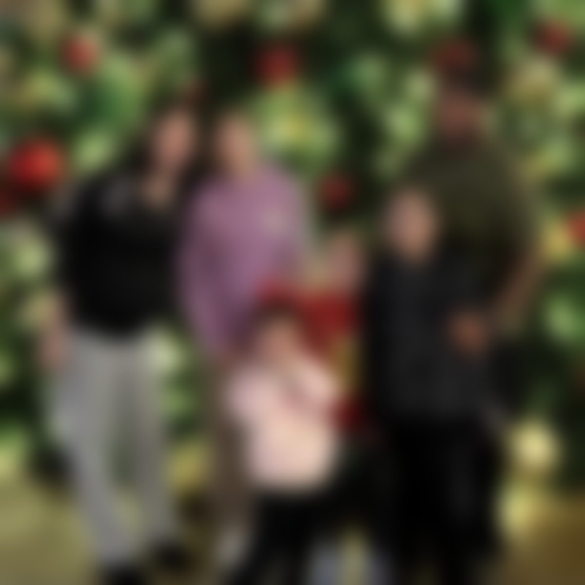 Brittney and her family by a Christmas tree
